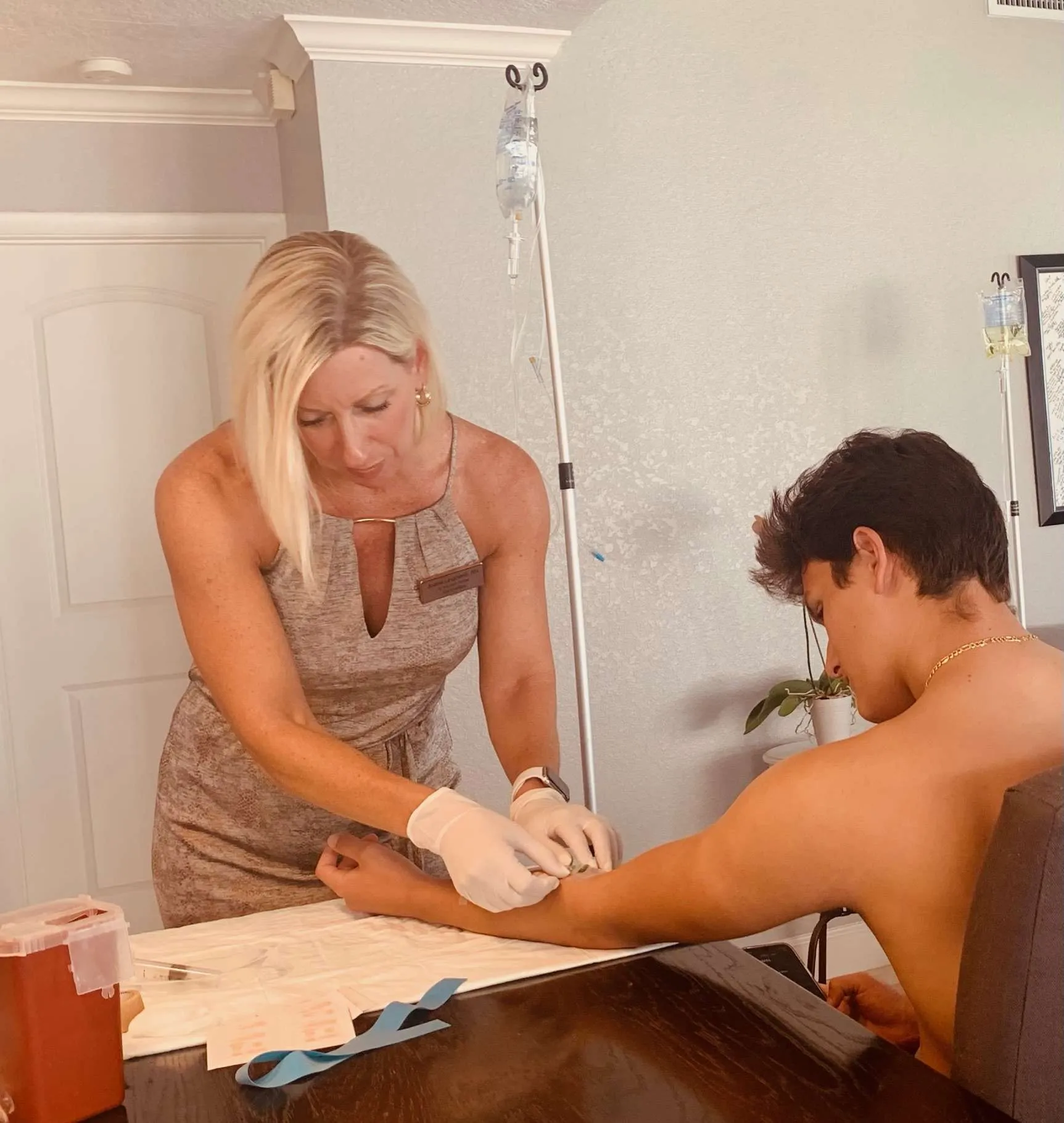 Client receiving a mobile IV therapy treatment in a comfortable setting.