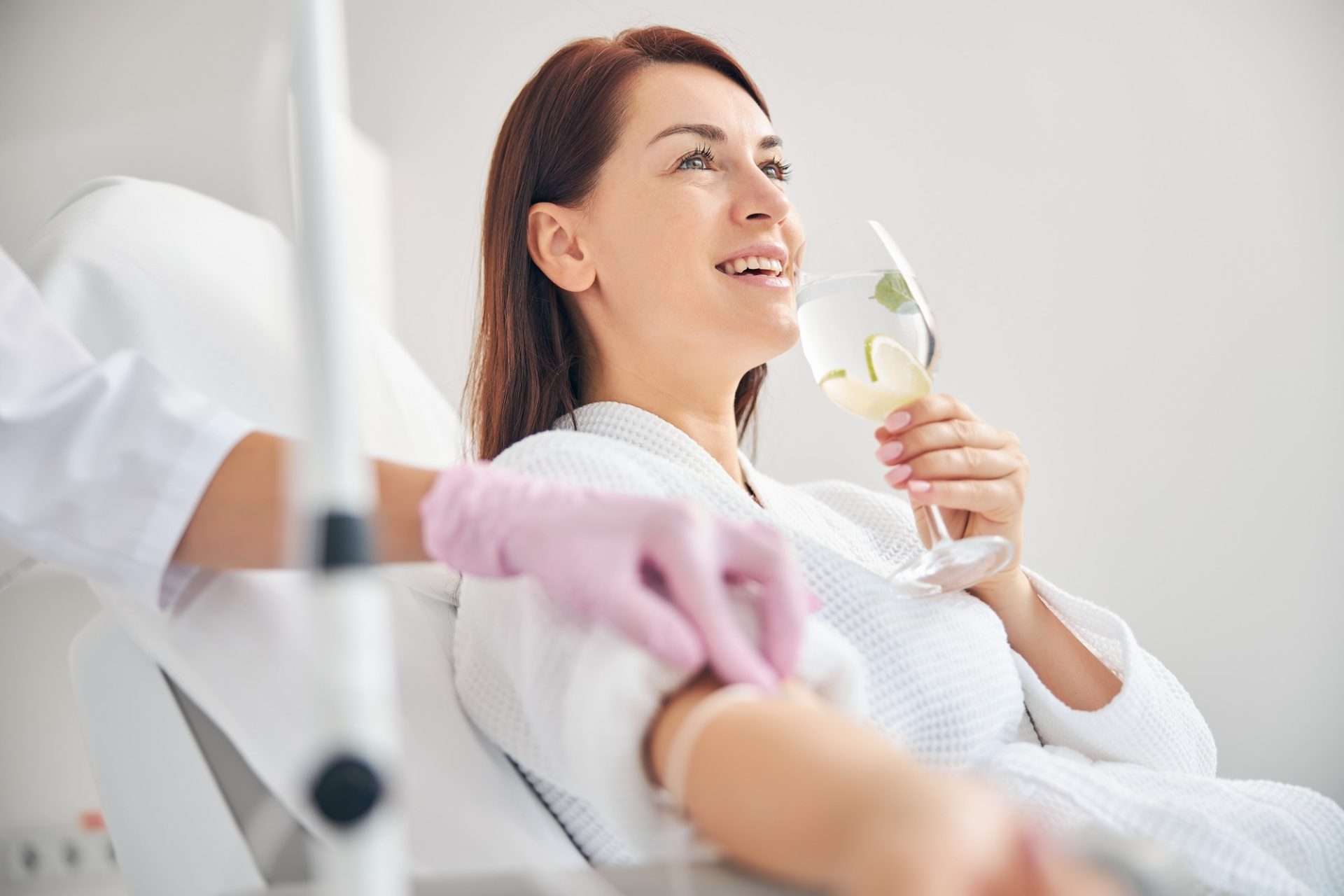 Client receiving a relaxing IV infusion treatment at home.